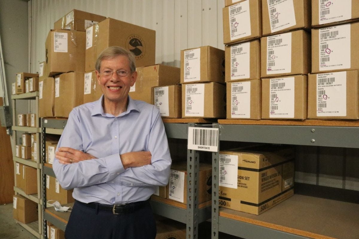 Walter Ulrich in a store room with boxes.