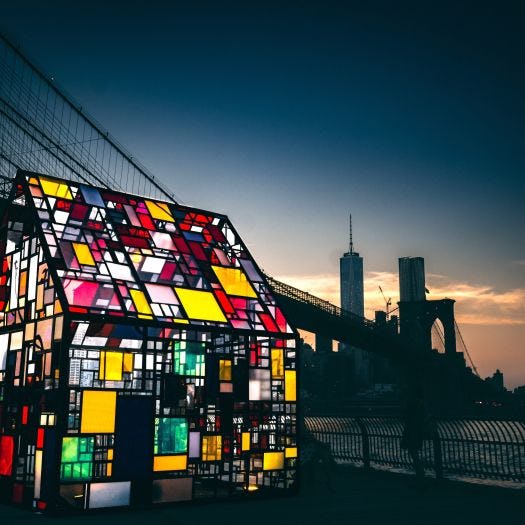 Mosaic-colored glass house by a New York City river