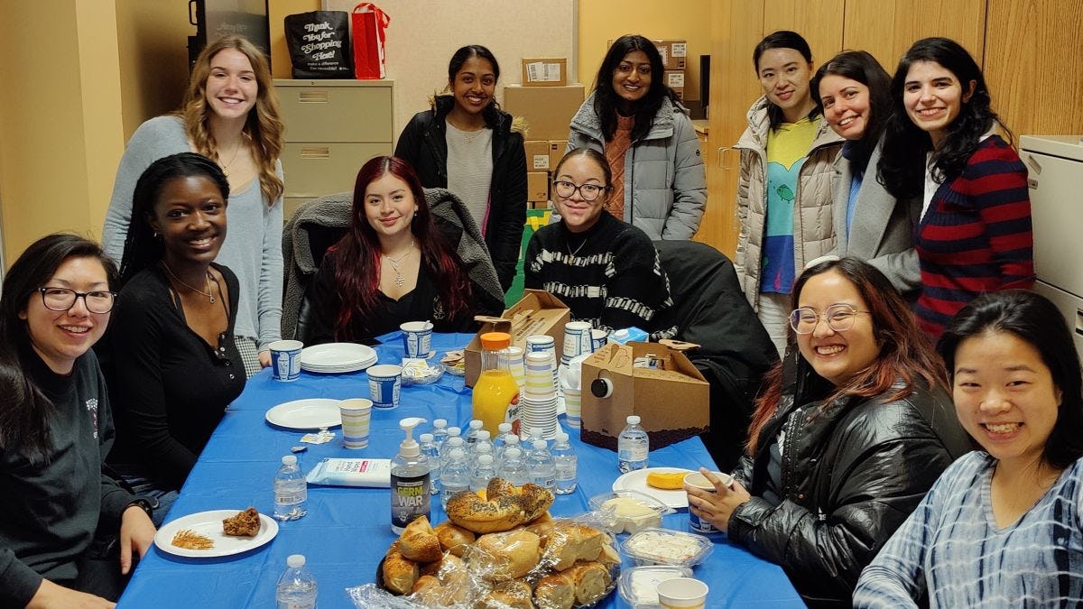 Female Stevens students gather for a bagel breakfast