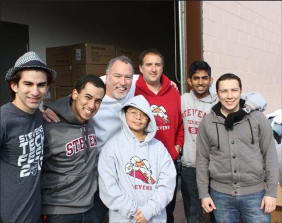 Professor Don Lombardi stands with a group of students after handing out food after Hurricane Sandy.