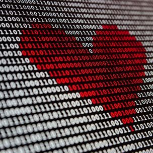 Digital code on computer screen with red-heart shape