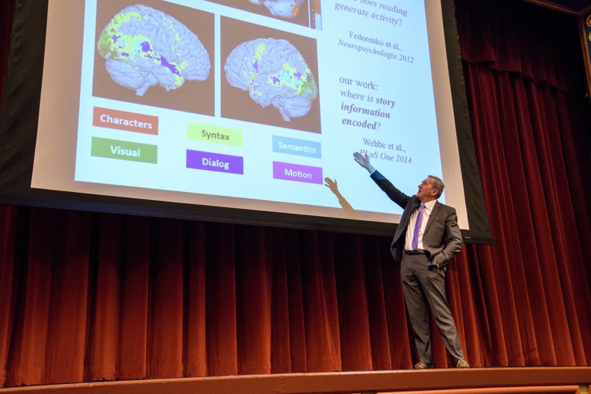 Dr. Tom Mitchell pointing brain scans on a projector
