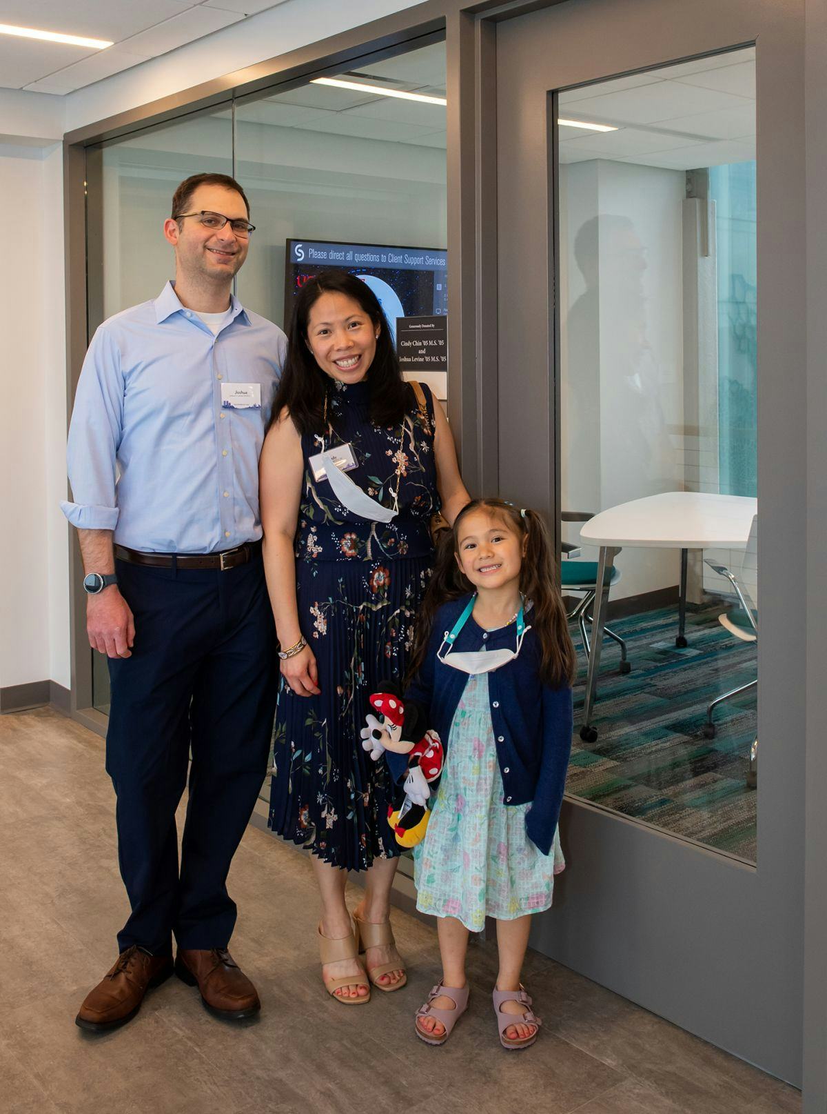 Cindy Chin, Joshua Levine and daughter Charlotte outside study room.