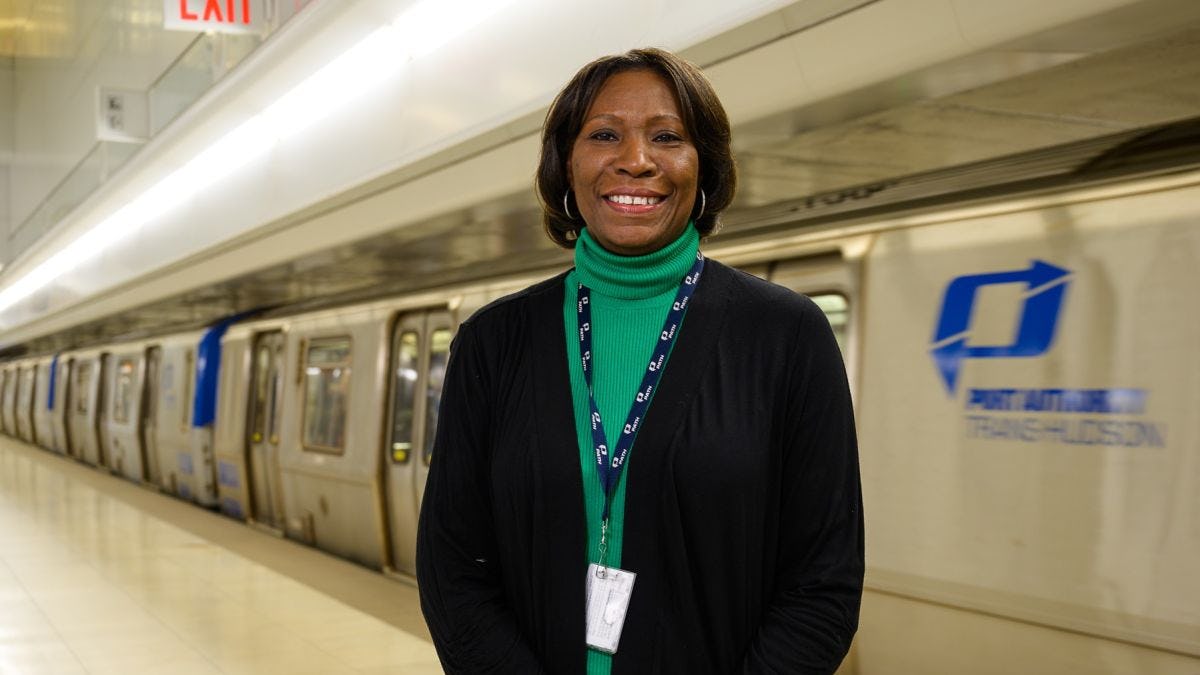 Clarelle DeGraffe standing next to a PATH train