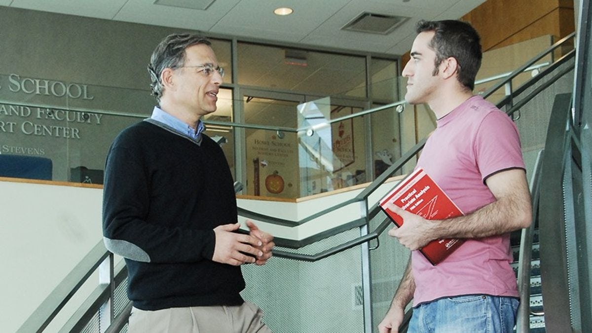 Zvi Aronson speaking with a graduate student at the School of Business.