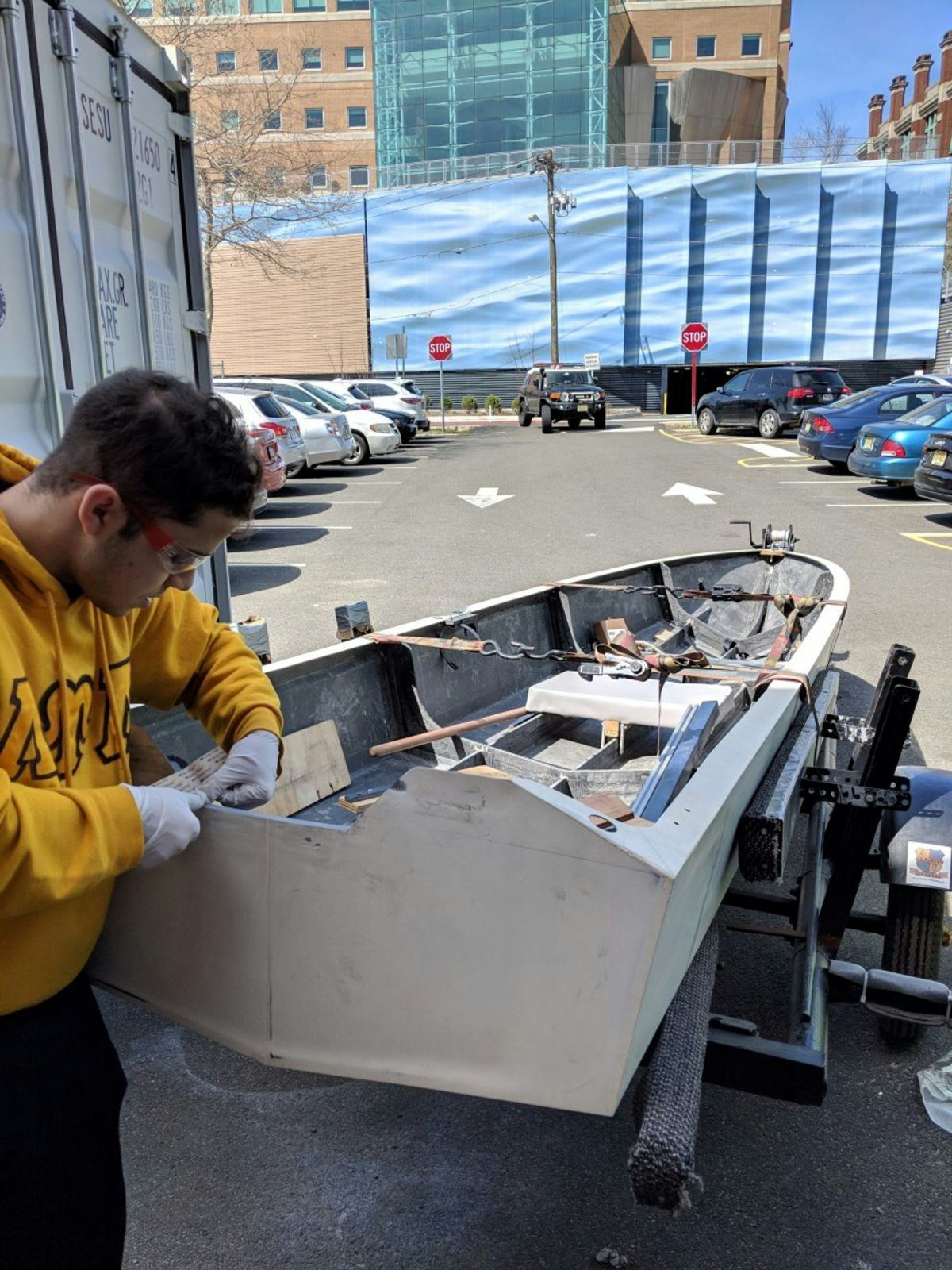 Student cutting the boat's transom to accommodate a new outboard unit