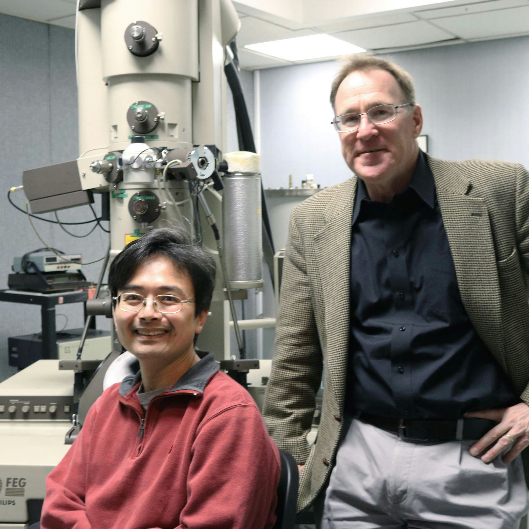 Research scientist Tsengming (Alex) Chou and professor Matthew Libera with the Philips CM20 field-emission transmission electron microscope. CREDIT: Stevens