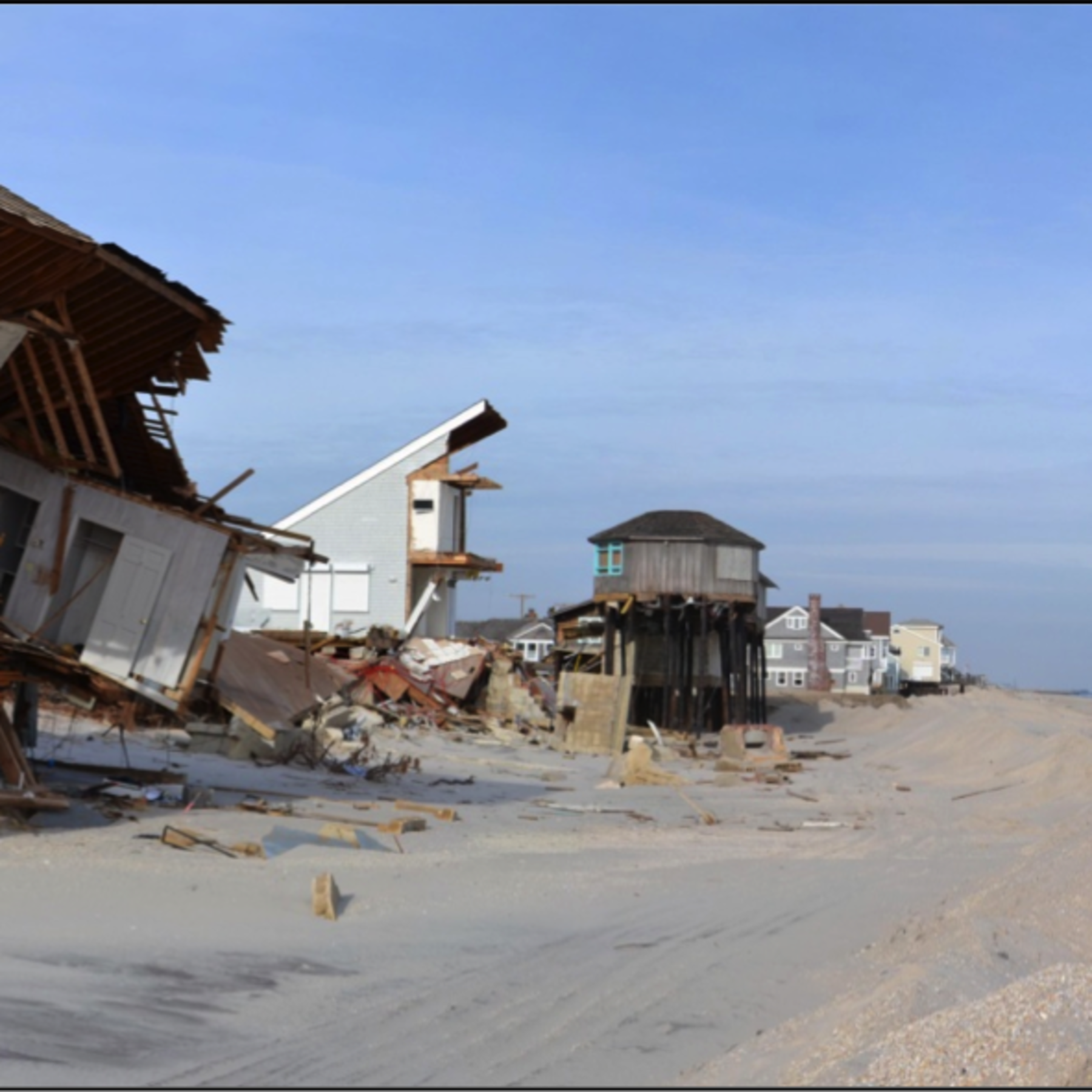 A photo of a destroyed house on the beach