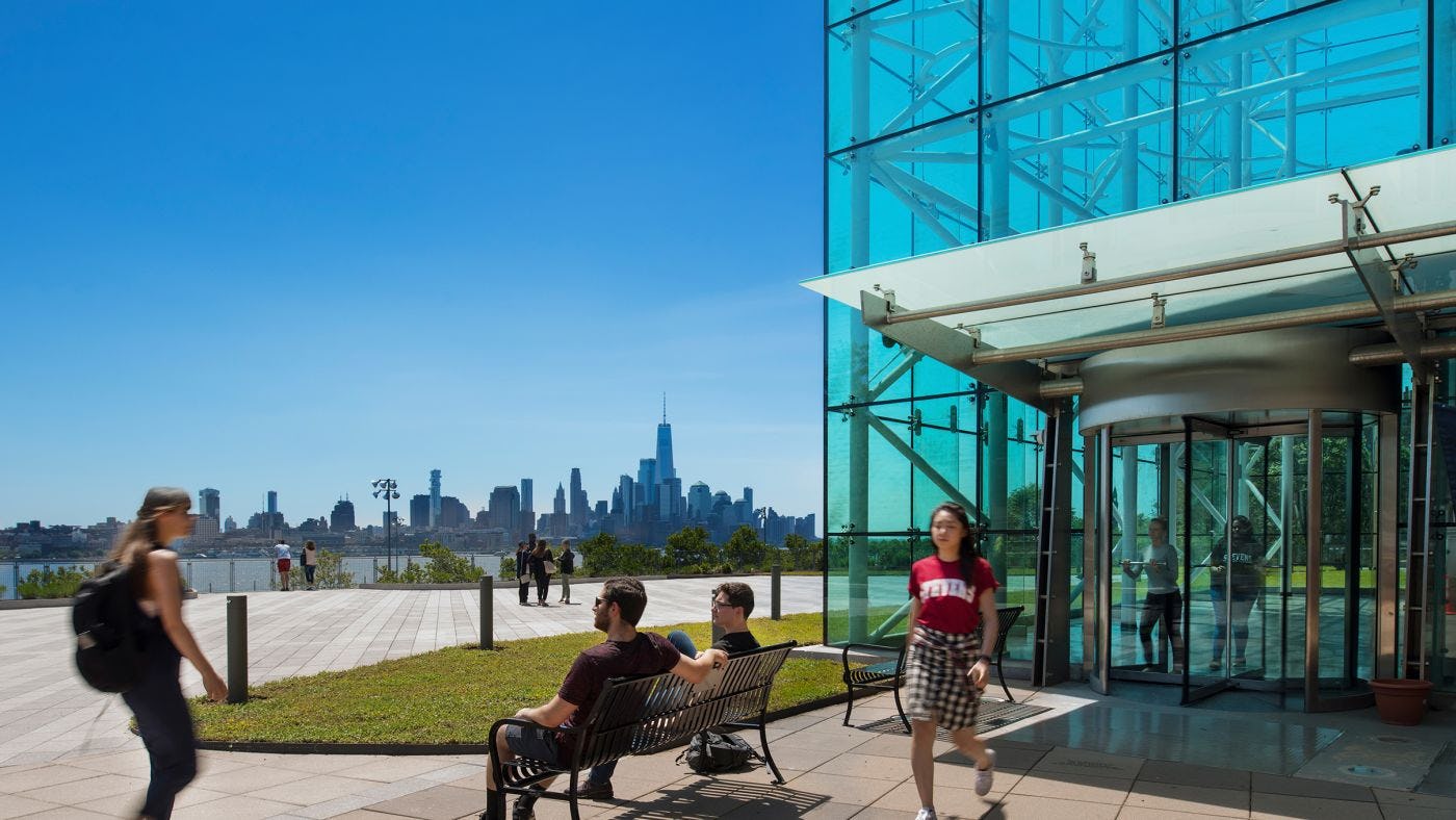 Students outside Babbio building with New York city in background.