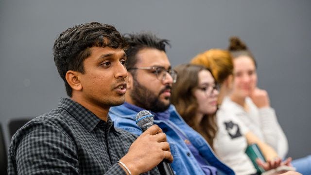 Alum speaks into microphone at Adulting 101 event