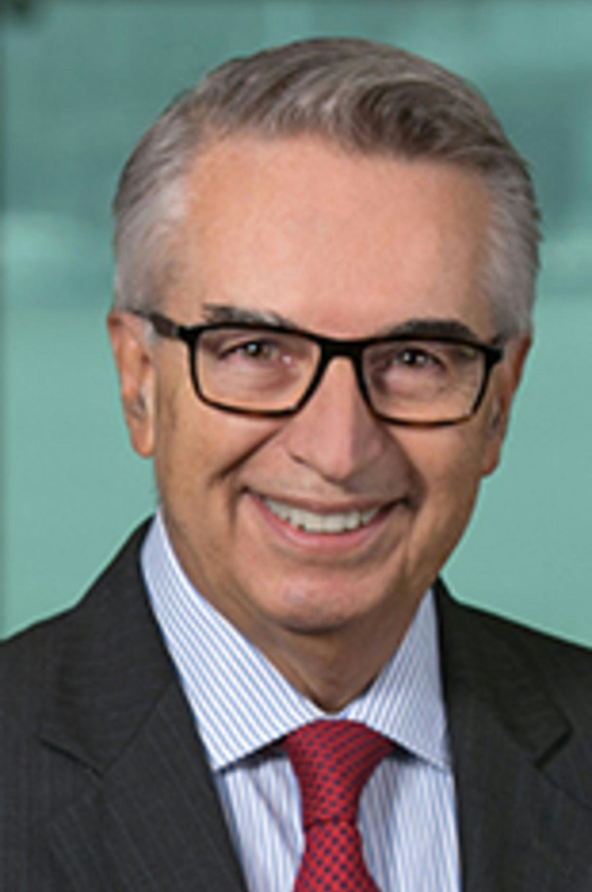 Headshot of Dr. Prastacos with the New York City skyline in the background.