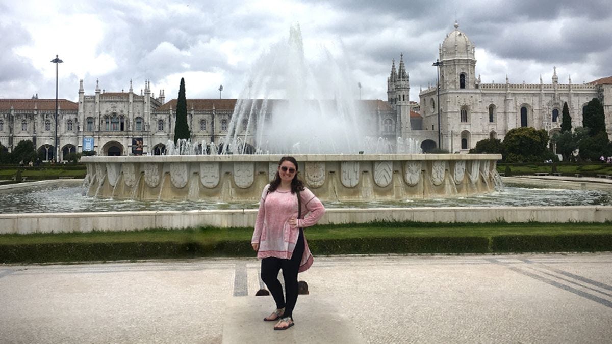 Devon Leslie in front of a fountain in Portugal.
