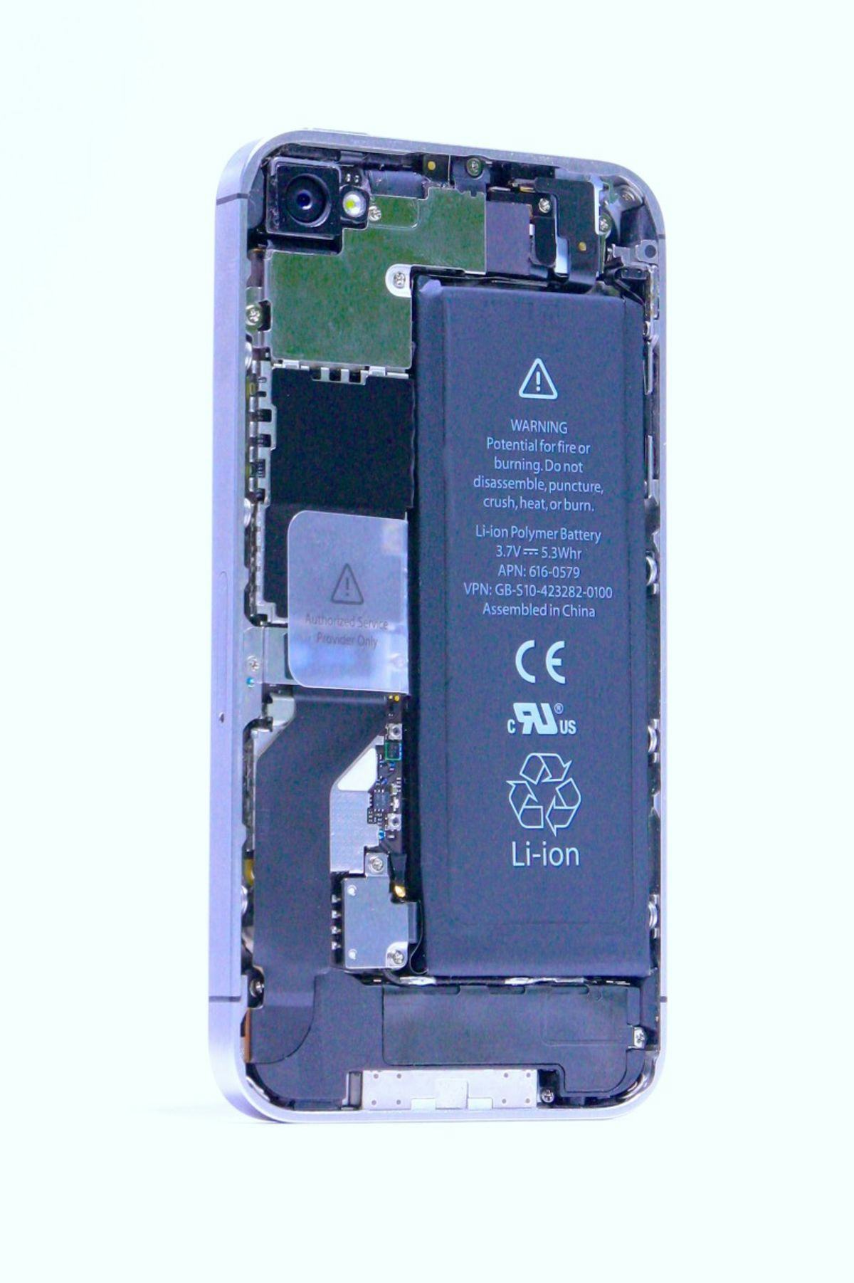 An opened smartphone, showing the battery inside