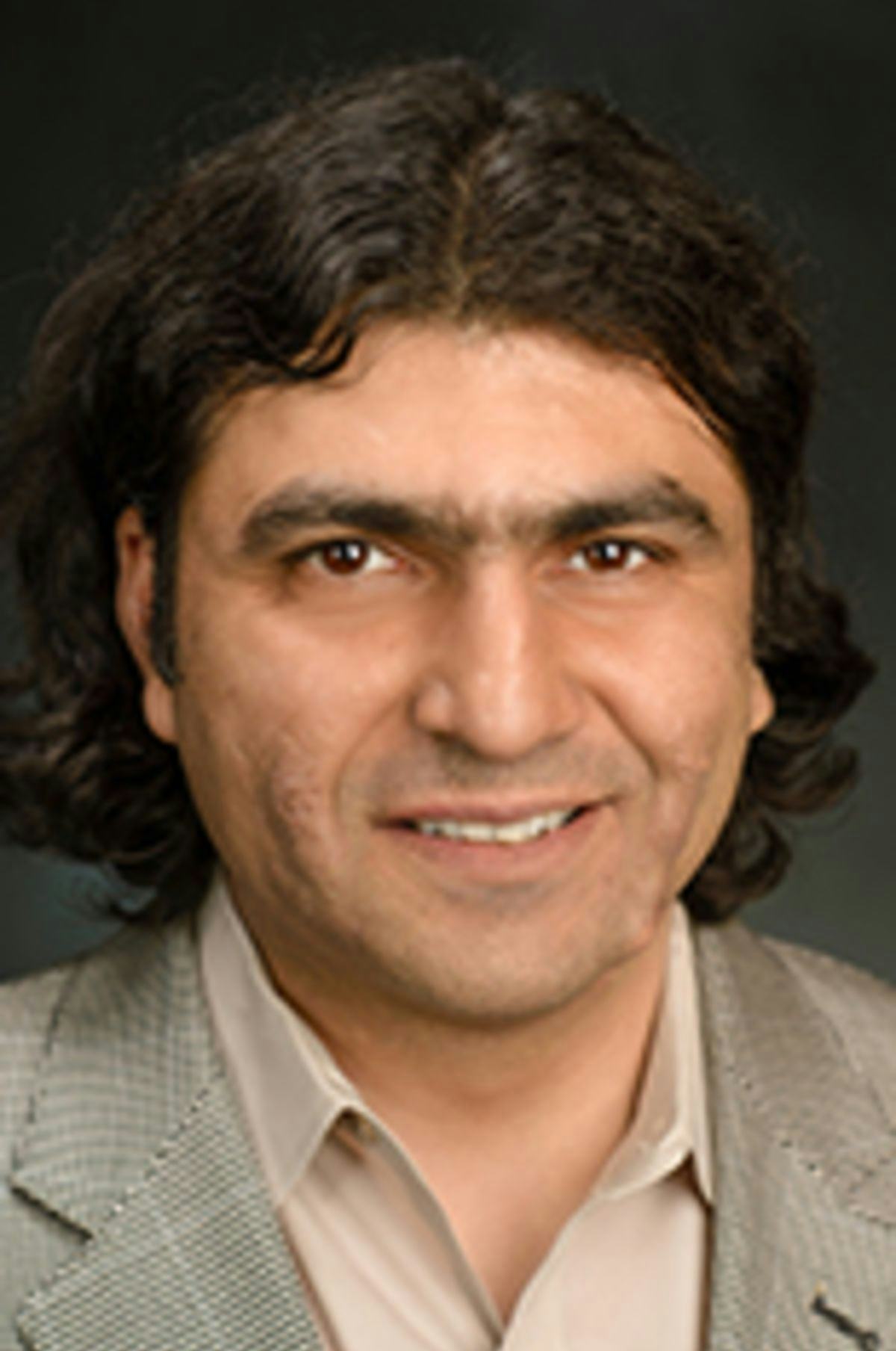 Headshot of Dr. Ionut Florescu in a light jacket in front of a dark background