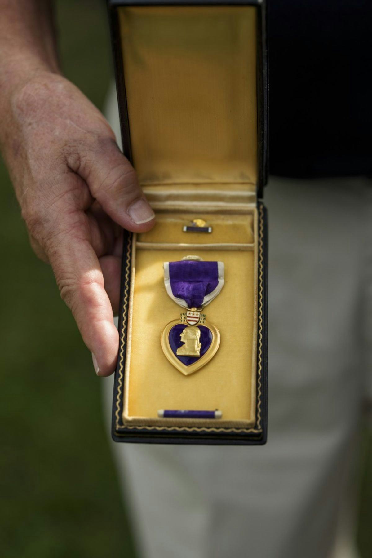 Bud Roedema '60 shows the Purple Heart that he earned in Vietnam