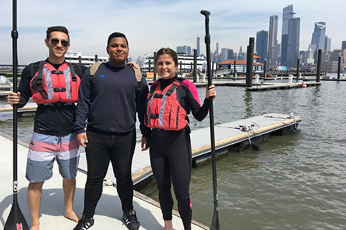 Three Stevens students on the docks alongside Pier 13 in Hoboken.