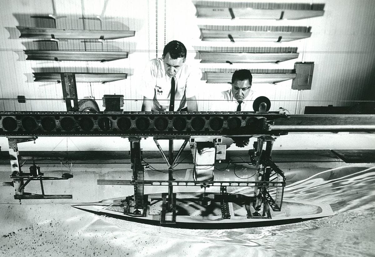 Daniel Savitsky M.S. ’52, right, and former Davidson Laboratory director John Breslin test a model of the yacht Constellation in 1964