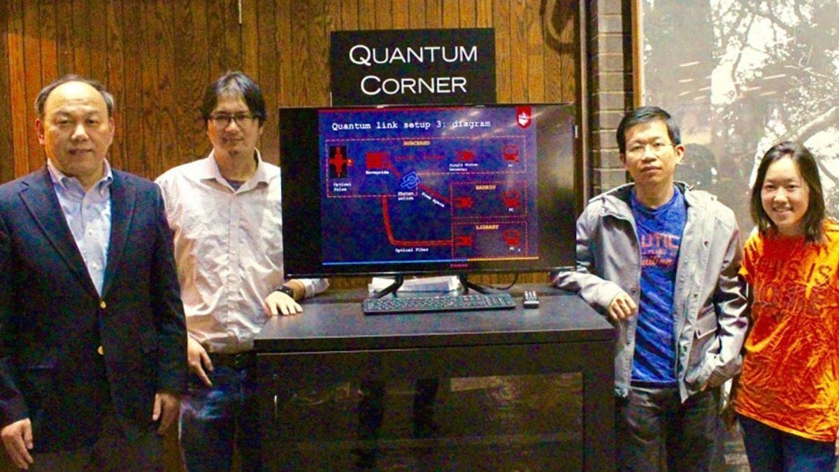 Yu and Huang with students with the Qauntum Corner in the library