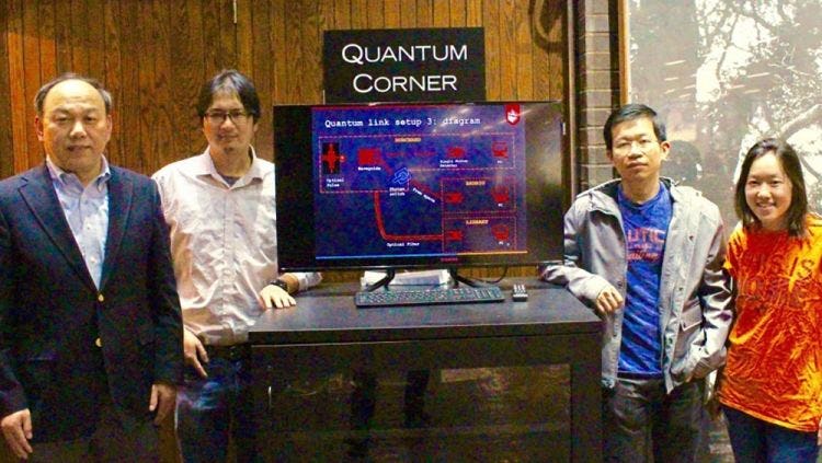 Yu and Huang with students with the Qauntum Corner in the library