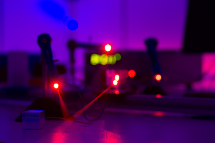 Laser beams in a photonics lab in the Department of Physics