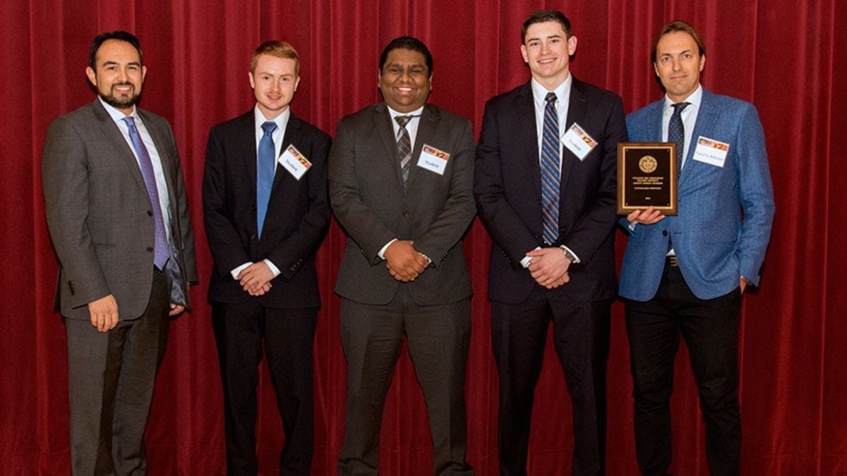The Fed Challenge team accepts its honorable mention award.