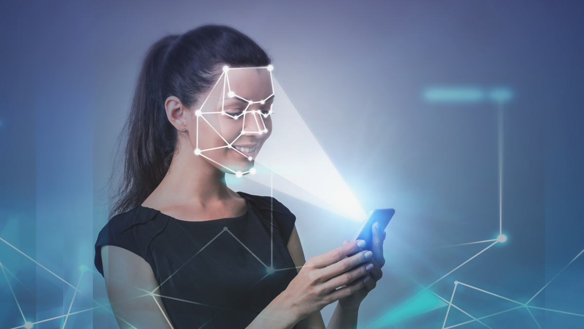 Woman holding phone showing facial recognition