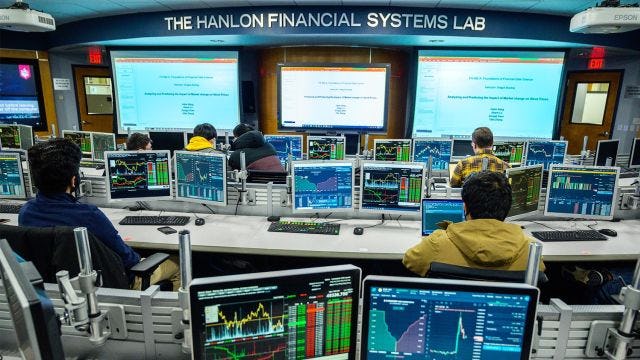 view of Hanlon Center from the back, with computer screens showing stock charts