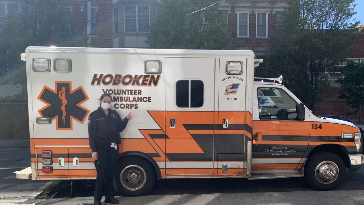 Nicole Badalyan in front of a Hoboken ambulance