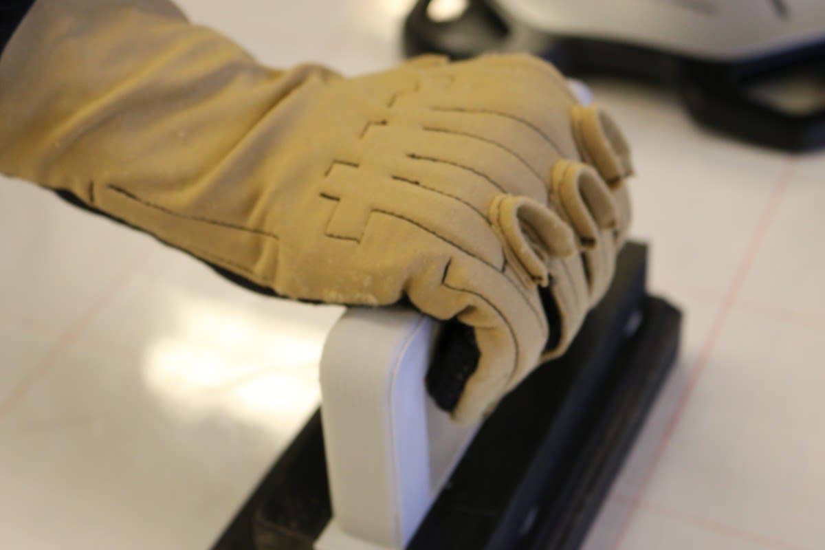 Patel demonstrates a grip test with her glove.