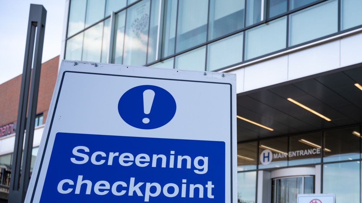 Hospital with sign indicating disease screening checkpoint