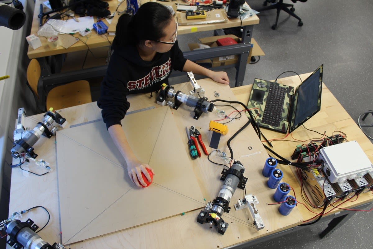 Qianwen Zhao, using her robot-assisted Haptic Joystick therapeutic device in the Wearable Robotic Systems Laboratory.