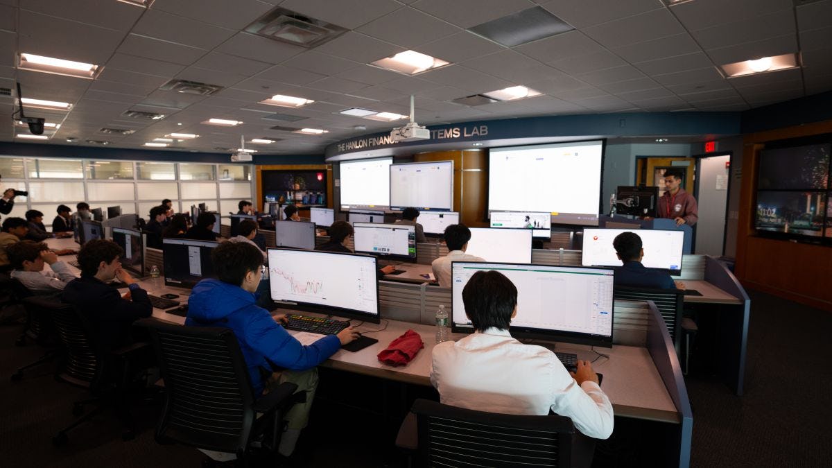 Participants in the trading day competition sit in front of their computer terminals inside the Hanlon Financial Systems Lab.