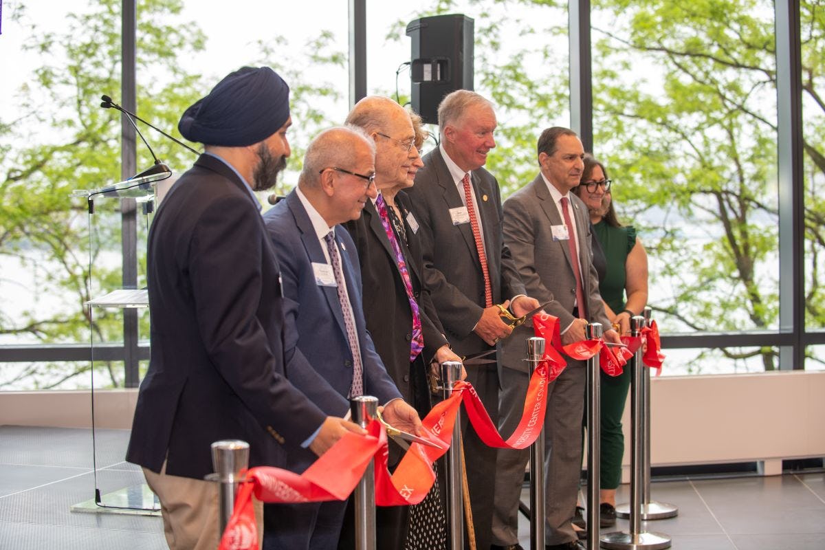 Members of the Stevens community cut red ribbon at ceremony.