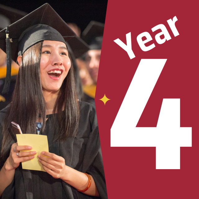 A female asian student wearing a cap and gown at graduate next to a graphic that says year four.